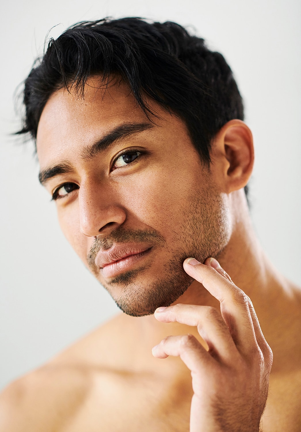 Close-up of male grooming and facial expression.
