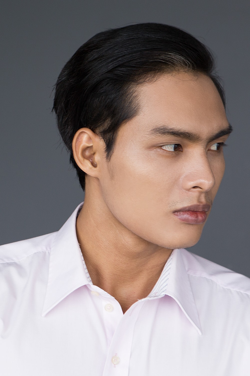 Profile of a man with short dark hair.