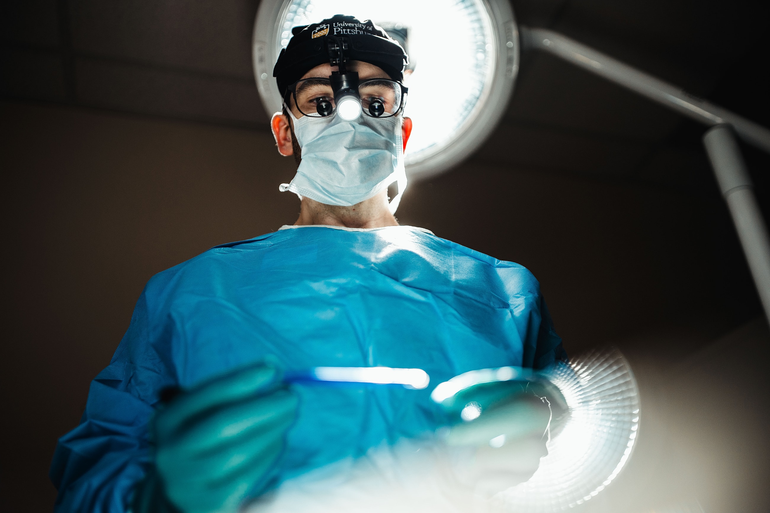 Surgeon preparing for surgery in operating room.