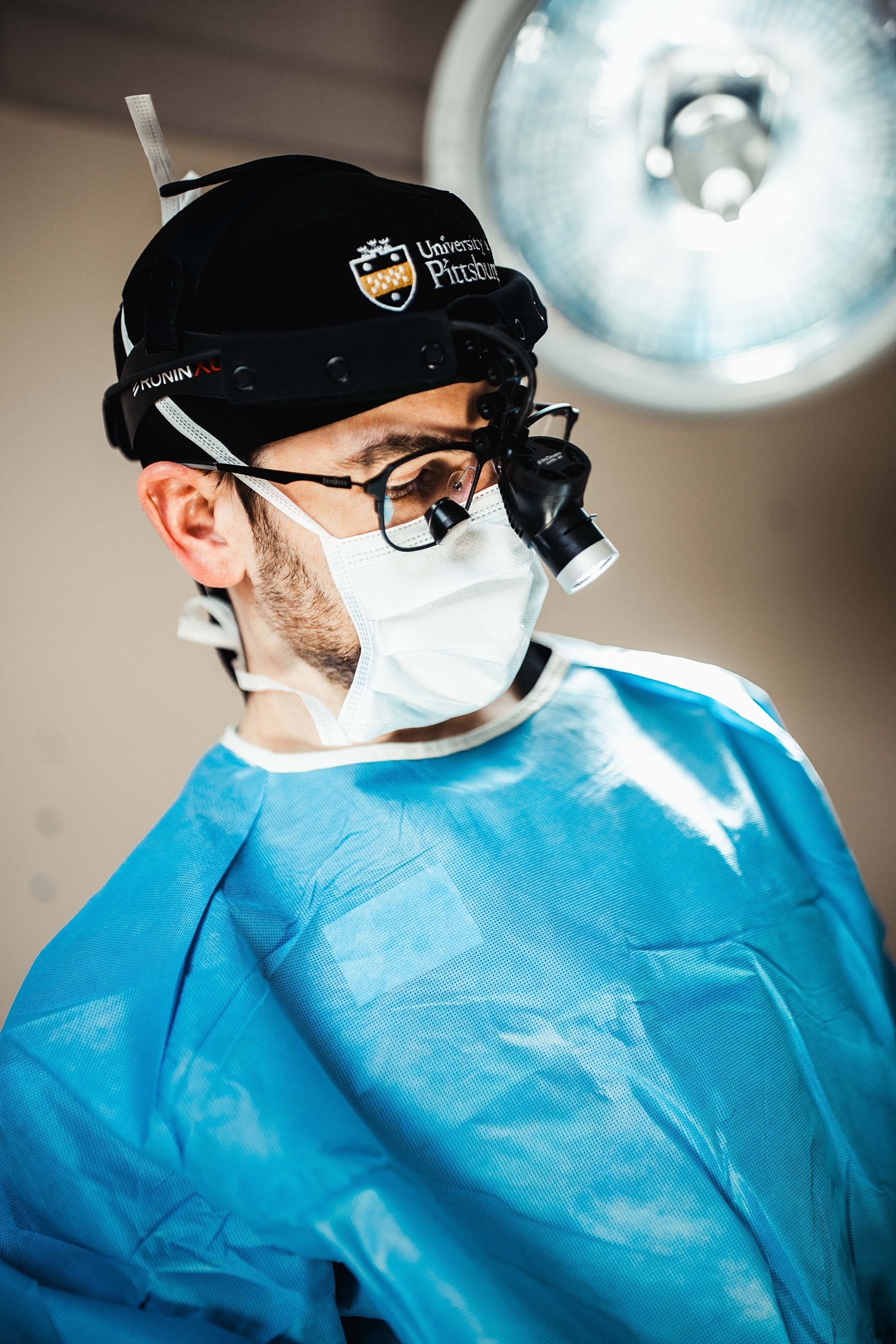 Surgeon preparing for a medical procedure in scrubs.